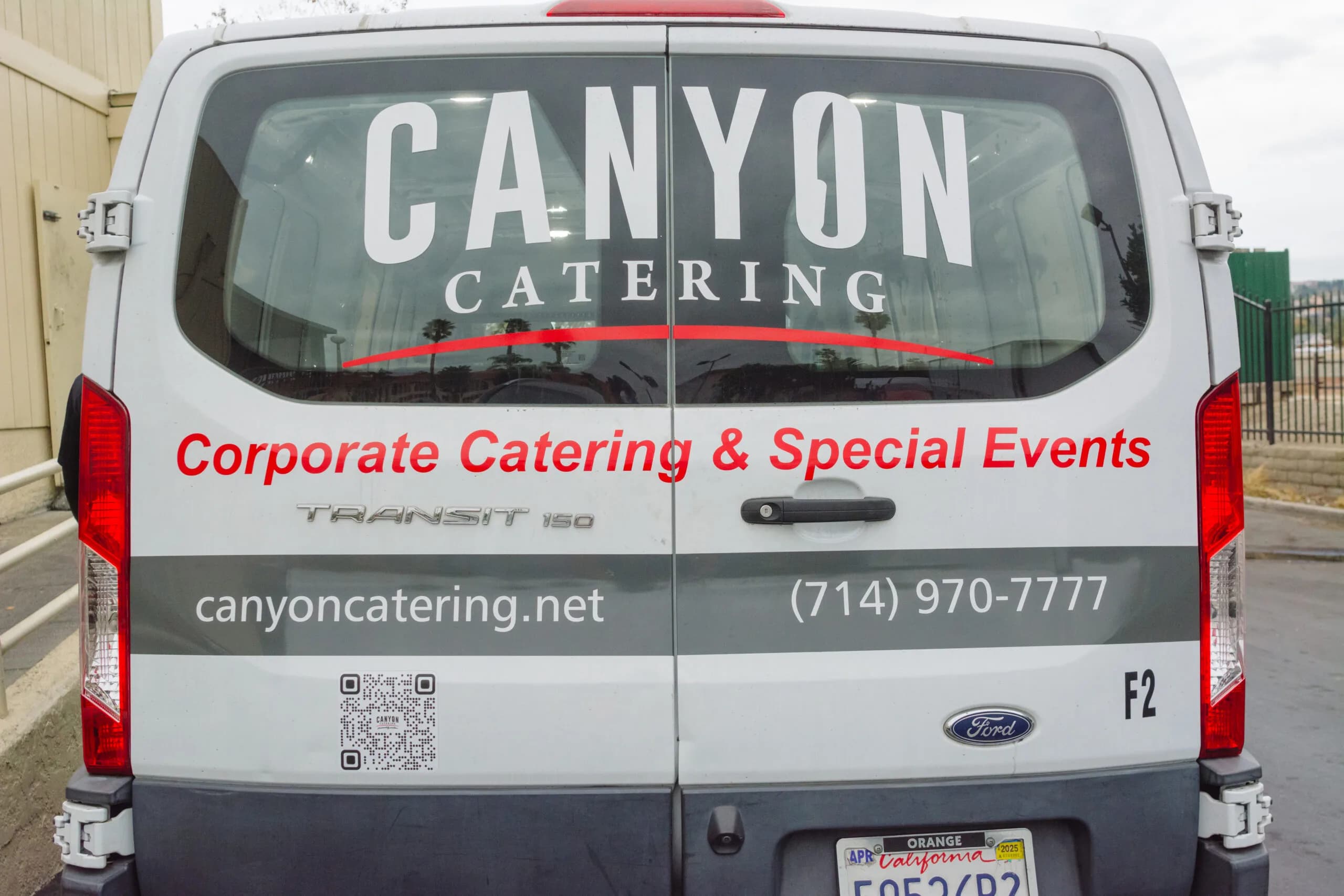 Canyon Catering van trunk with website and phone number decals for corporate catering Orange County out for pantry stocking service delivery