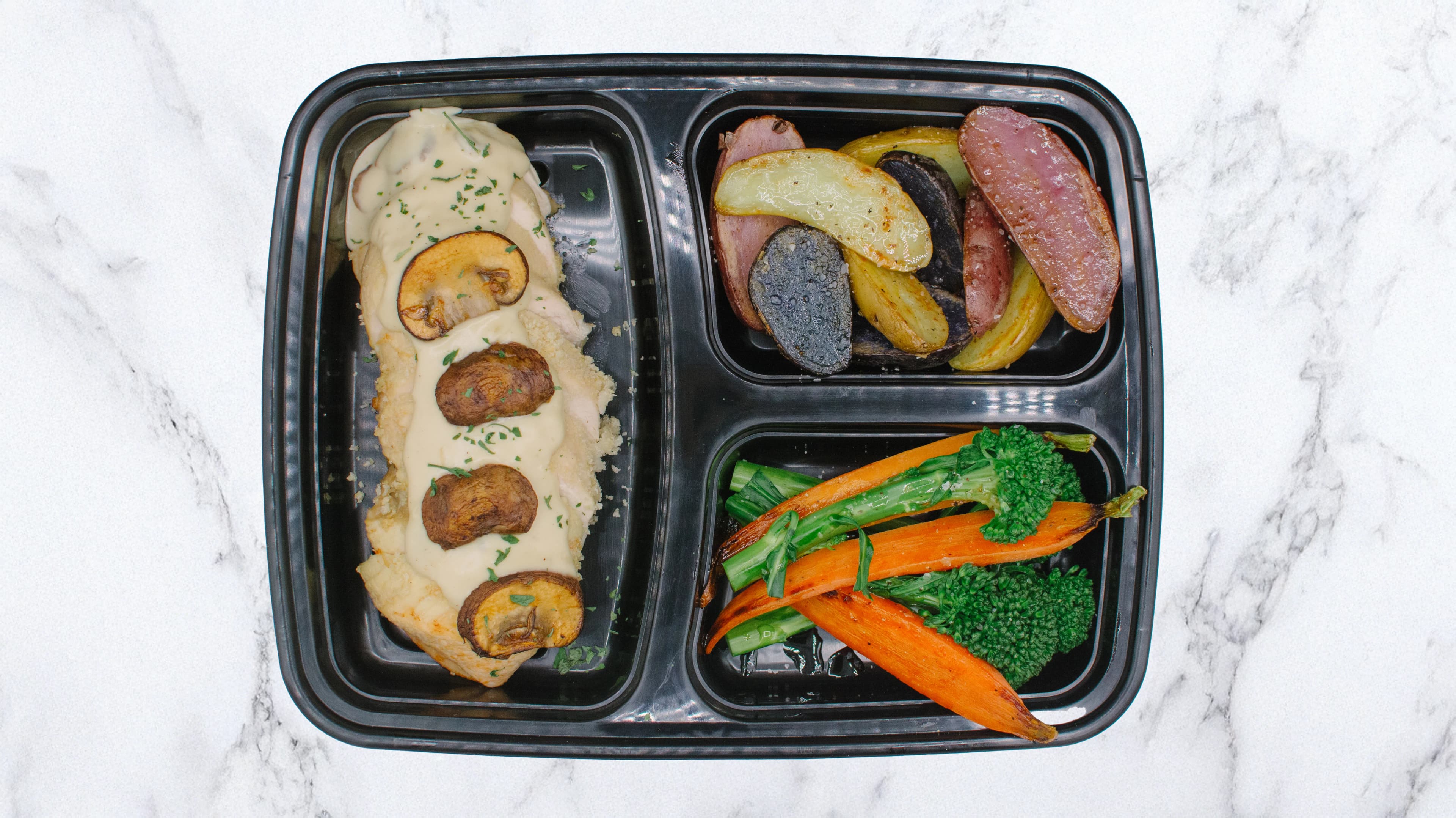 Fresh pre-portioned office meal kit with roasted veg, potato wedges, and chicken - a great business boxed lunch delivery